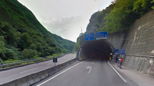 Cyclist stopped at a tunnel entrance