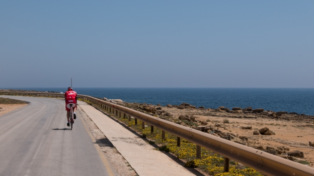 Cyclist on the coast road near Mazara del Vallo