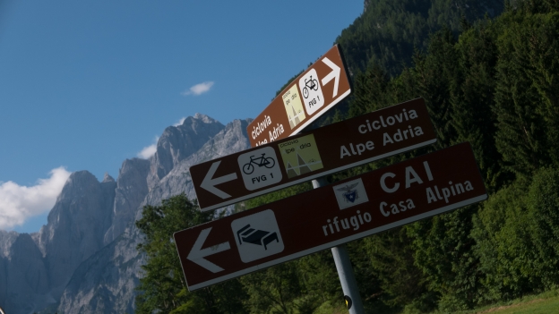 Signs on the Ciclovia Alpe-Adria Radweg near Valbruna