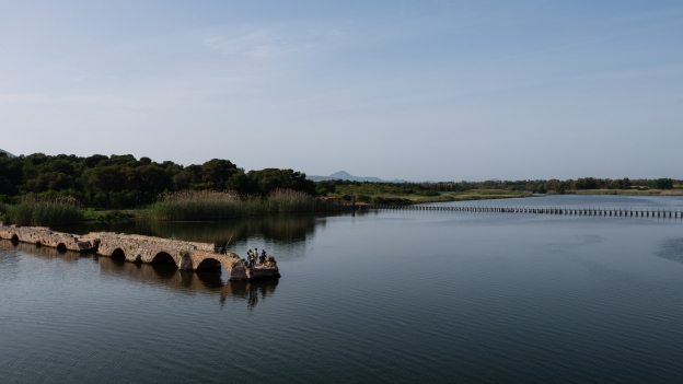 Fishing from the old Roman bridge across the Calik laguna at Fertilia