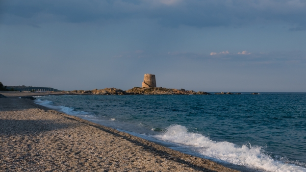 The beach at Bari Sardo with the Torre di Bari Sardo
