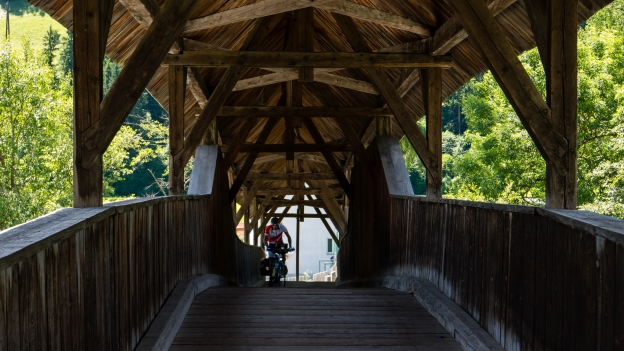 Cyclist on the wooden bridge over the Inn near Landeck