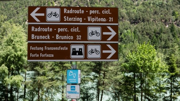 Signs on the Brennerradroute near Franzensfeste (Fortezza). Route markers for the München-Venezia and Südtirol Radweg (Ciclovia Alto Adige) cycle routes