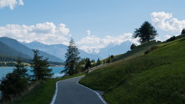 Etschradroute The Etschradroute cycleway on the western shore of the Reschensee (Lago di Resia), looking south towards the snow-covered Italian Alps
